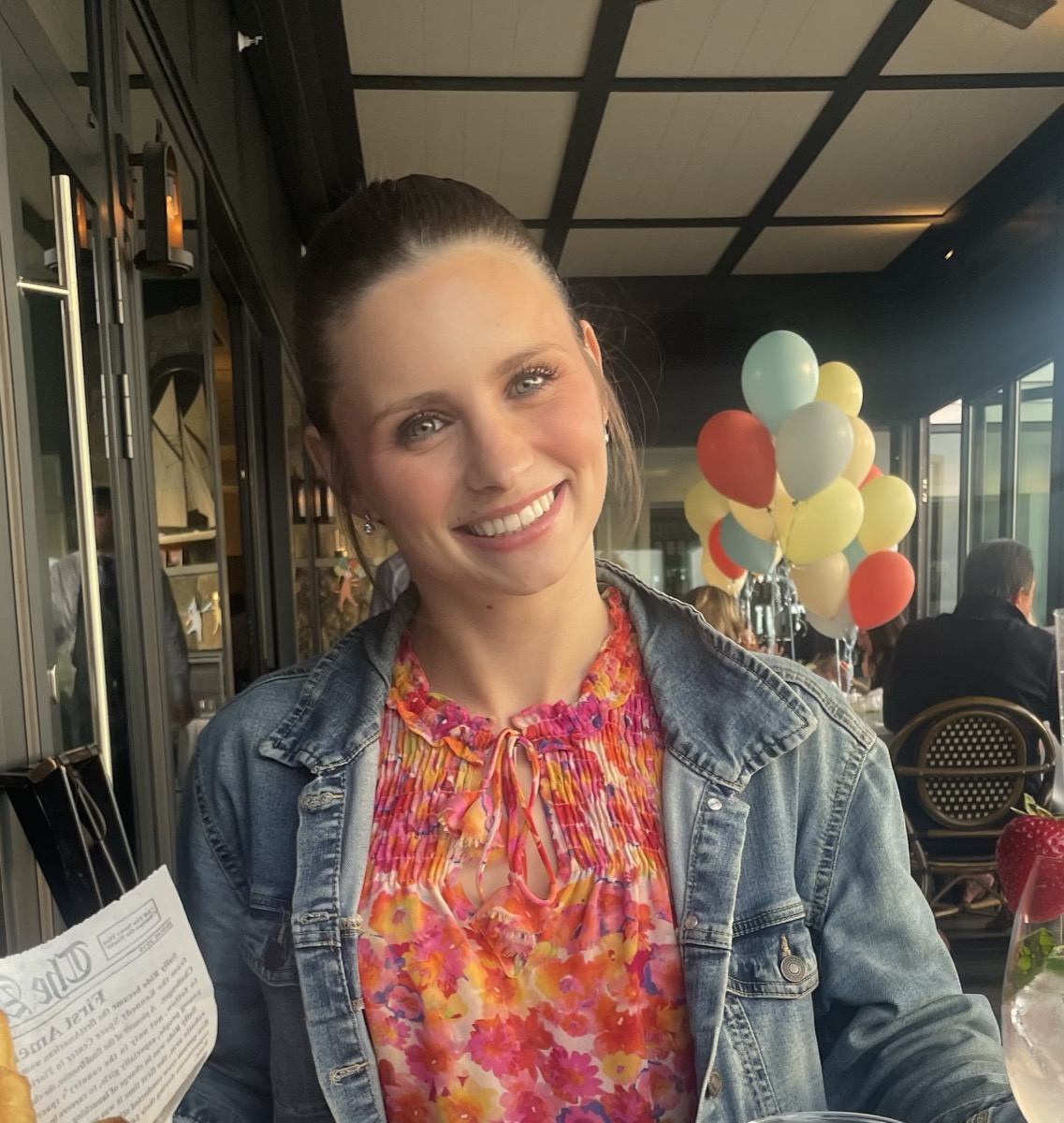 Liv smiling at a table